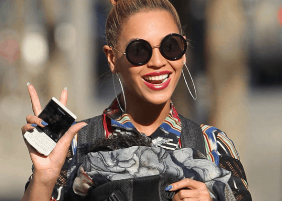 Beyonce with her BlackBerry Porsche, which cost a mere $2000.