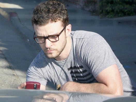 Justin Timberlake takes a picture of his car with his BlackBerry. 