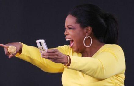 Oprah Winfrey takes a picture of her studio audience with a BlackBerry. 