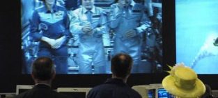 She's not new to this space thing. England's Queen Elizabeth II hears from the three-astronaut crew of Expedition 15 aboard the International Space Station. British-born NASA astronaut Mike Foale (center) hosted the May 8, 2007 event at the Goddard Space Center in Greenbelt, Maryland.