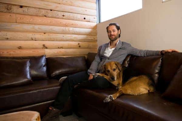 HootSuite CEO Ryan Holmes sits with his dog Mika. Many HootSuite employees bring their dogs to the office daily.