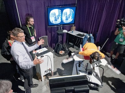 Vancouver Mayor Gregor Robertson observes "Birdly" in action at the Emerging Technologies area at SIGGRAPH 2014. Photo © SIGGRAPH 2014.