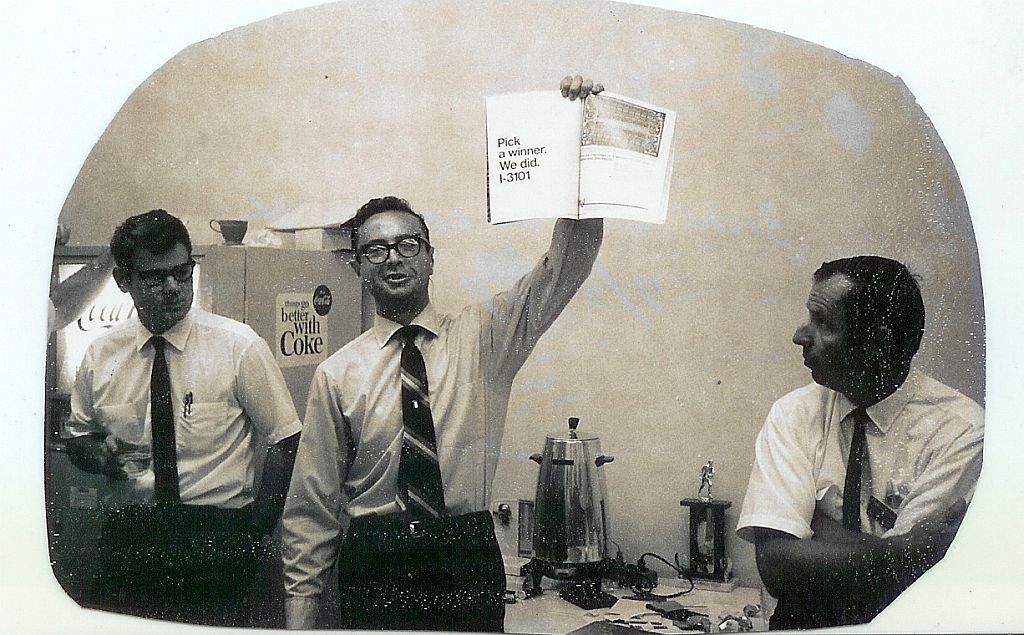 In 1969, Andy Grove, then COO, holds an advertisement for the Intel 3101, the world's first solid-state memory device and Intel's first product.